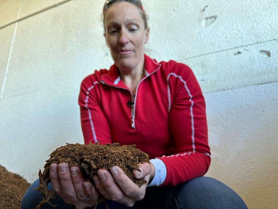 Gignac with a handful of the composted material. 'It's like Christmas,' she said. 