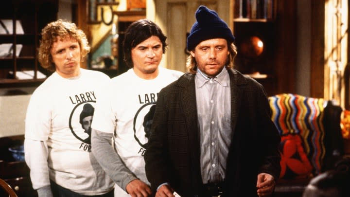 Larry, Darryl, and Darryl from Newhart standing in a row. 