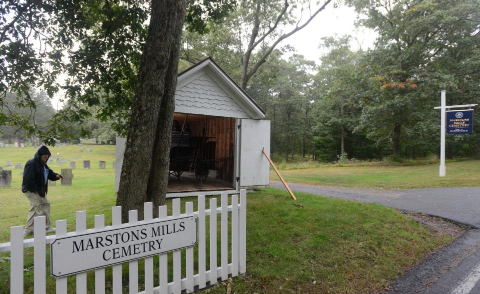 David Martin, president of the Marstons Mills Historical Society makes towards the town's old horse drawn hearse housed in a small shed dating to 1880 at the Marstons Mills Cemetery off Route 149 in that town.