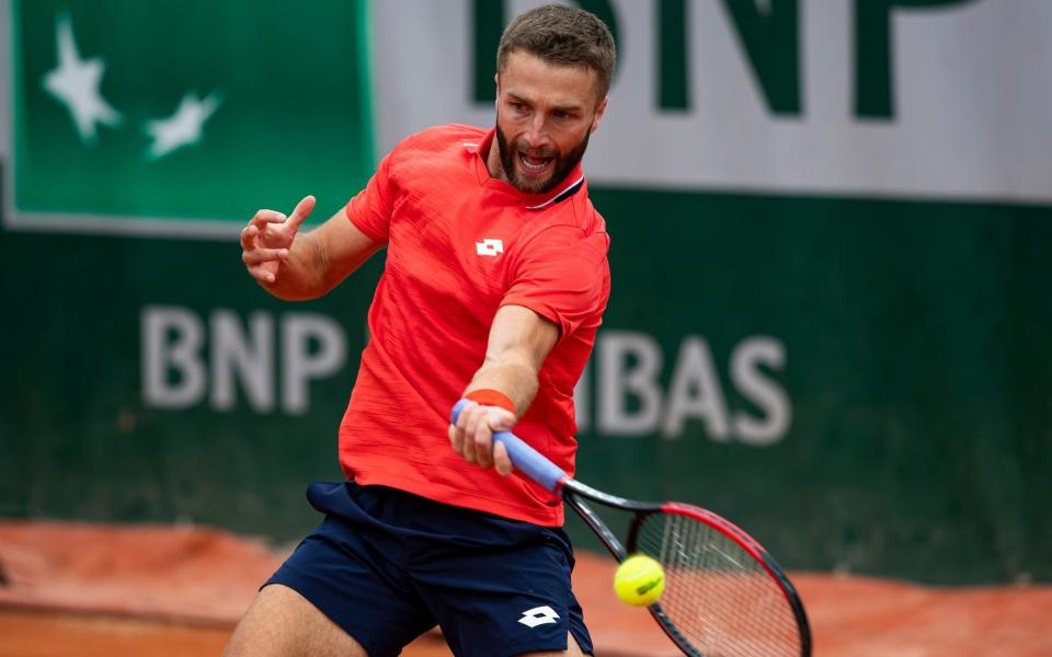 Liam Broady of Great Britain hits a forehand against Jiri Vesely  - GETTY IMAGES