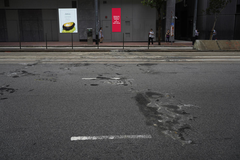 In this Sept. 19, 2019, photo, burn-marks from home-made petrol bomb and burnt barriers remain at the street in Wanchai area in Hong Kong. As Hong Kong enters its fourth month of steady protests, the city is embracing for another violent weekend prior to the upcoming 70th National Day on Oct. 1. (AP Photo/ Vincent Yu)
