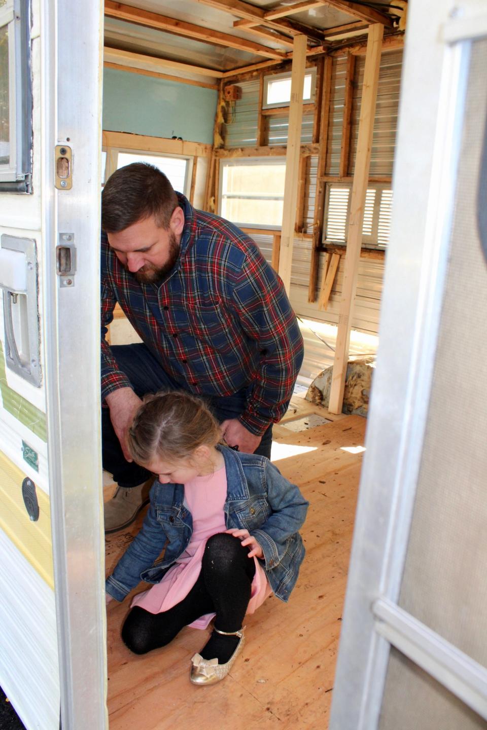Shane Reilly and his daughter help renovate the trailer that will become home to Buster's Bookhouse in Somerset.