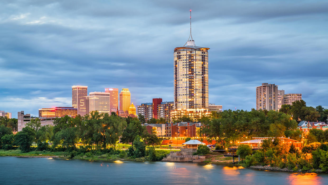 Tulsa, Oklahoma, USA downtown skyline on the Arkansas River at dusk.