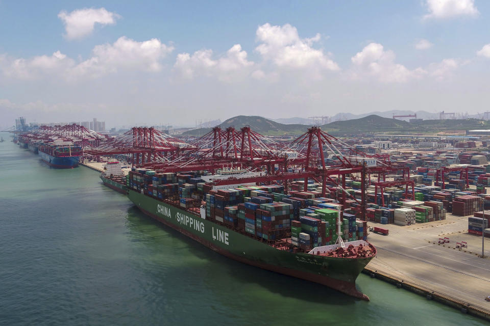 In this Aug. 6, 2019, photo, a container ship is docked a port in Qingdao in eastern China's Shandong province. U.S. President Donald Trump angrily escalated his trade fight with China on Friday, Aug. 23, 2019, raising retaliatory tariffs and ordering American companies to consider alternatives to doing business there. (Chinatopix via AP)