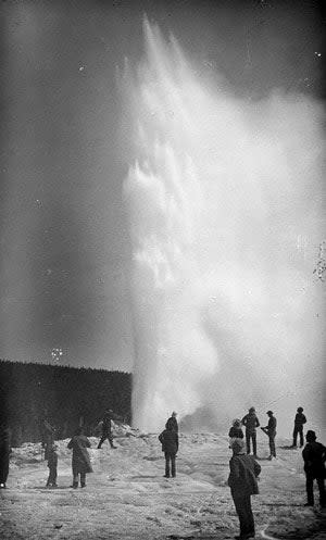 People standing at Old Faithful in the 1800's