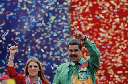 Venezuela's President Nicolas Maduro and his wife Cilia Flores greet supporters during his closing campaign rally in Caracas, Venezuela May 17, 2018. REUTERS/Carlos Jasso