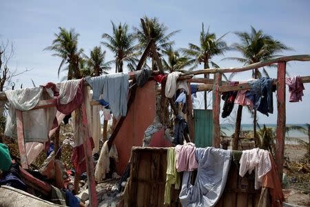 Clothes hang on the remains of a house destroyed by Hurricane Matthew in Les Anglais, Haiti, October 10, 2016. REUTERS/Andres Martinez Casares