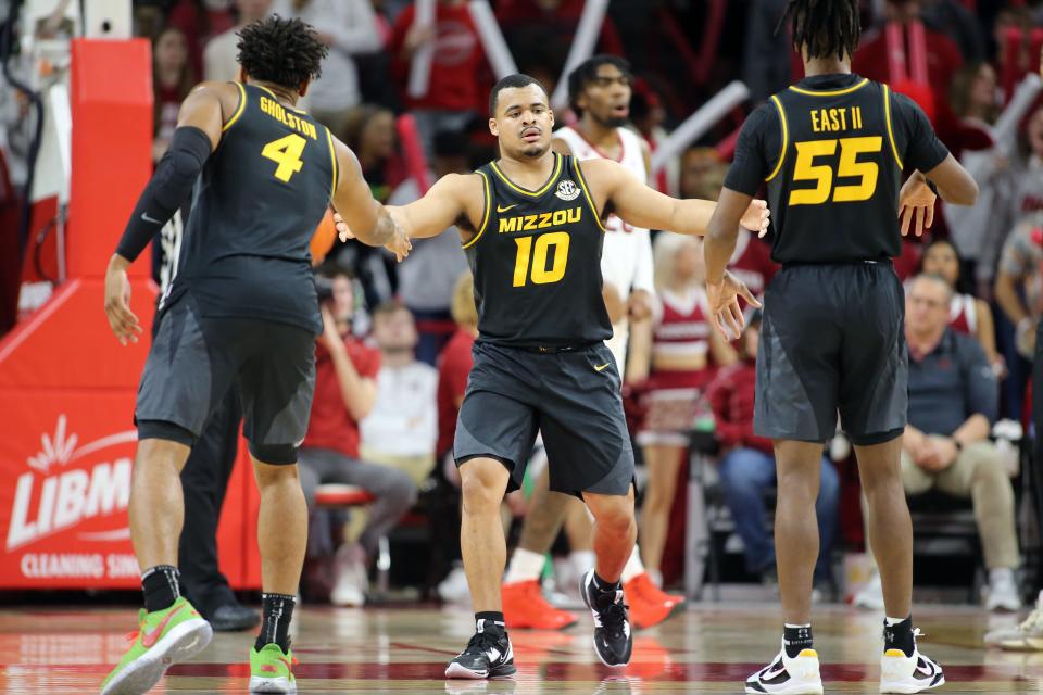 Missouri Tigers guard Nick Honor (10) celebrates after a play in the first half against the Arkansas Razorbacks at Bud Walton Arena.