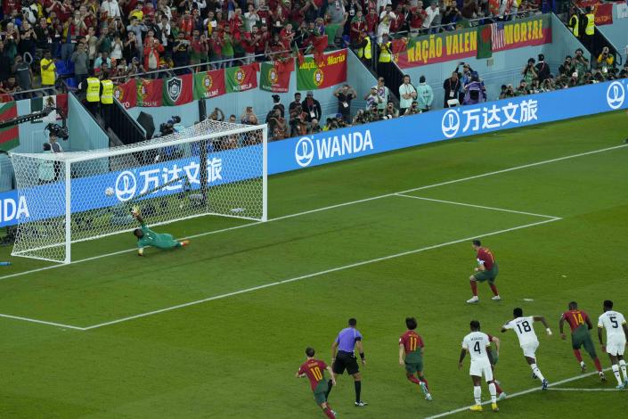 Portugal's Cristiano Ronaldo scores from the penalty spot during the World Cup group H soccer match between Portugal and Ghana, at the Stadium 974 in Doha, Qatar, Thursday, Nov. 24, 2022. (AP Photo/Francisco Seco)