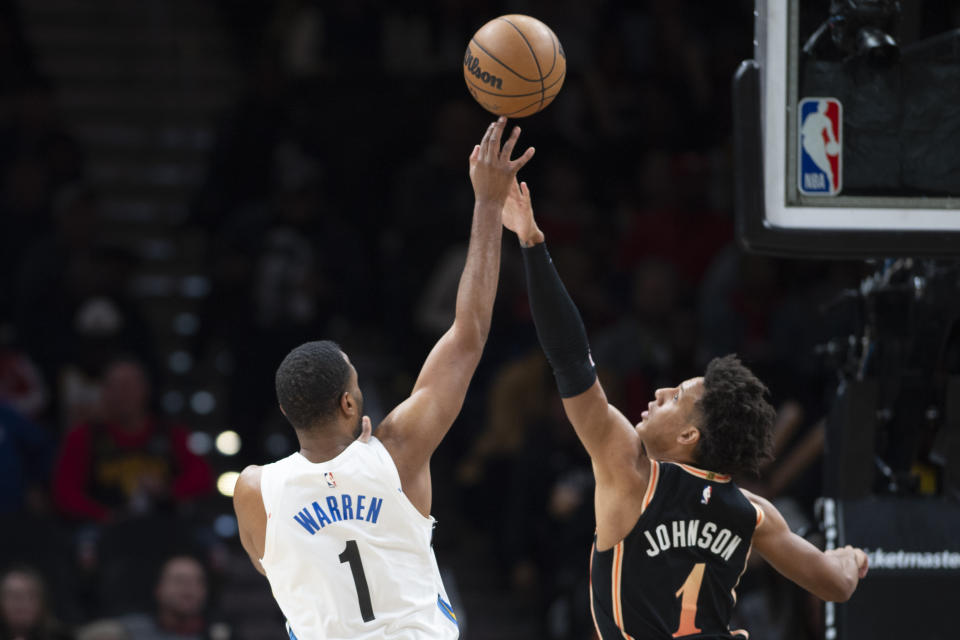 Brooklyn Nets forward T.J. Warren (1) shoots against Atlanta Hawks forward Jalen Johnson during the first half of an NBA basketball game, Wednesday, Dec. 28, 2022, in Atlanta. (AP Photo/Hakim Wright Sr.)