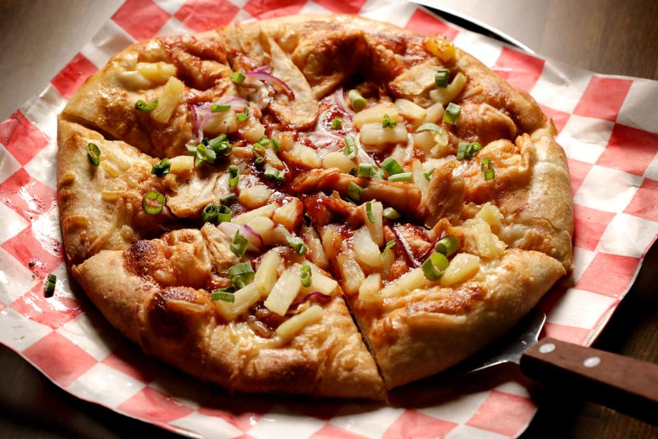 Wild Pie's BBQ Chick'n pizza is made with smoky BBQ sauce, plant-based chicken, dairy-free mozzarella, pineapple, red onion and green onion.