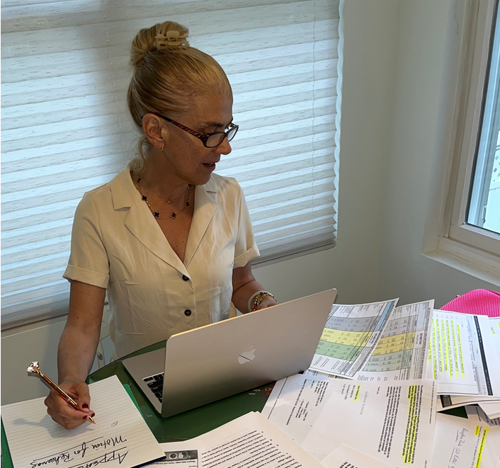 Yvette Donato reviews materials for her lawsuit and tax appeal related to her Palm Beach home, which she tried to homestead. She was successful but her taxable value had more than doubled, generating a tax bill of more than $50,000. She is contesting a property appraiser's office decision that reset the home's value after she applied for the homestead exemption. State Rep. Mike Caruso-R-Delray Beach, is working with her to create a law that would address her issue.
(Credit: Contributed)