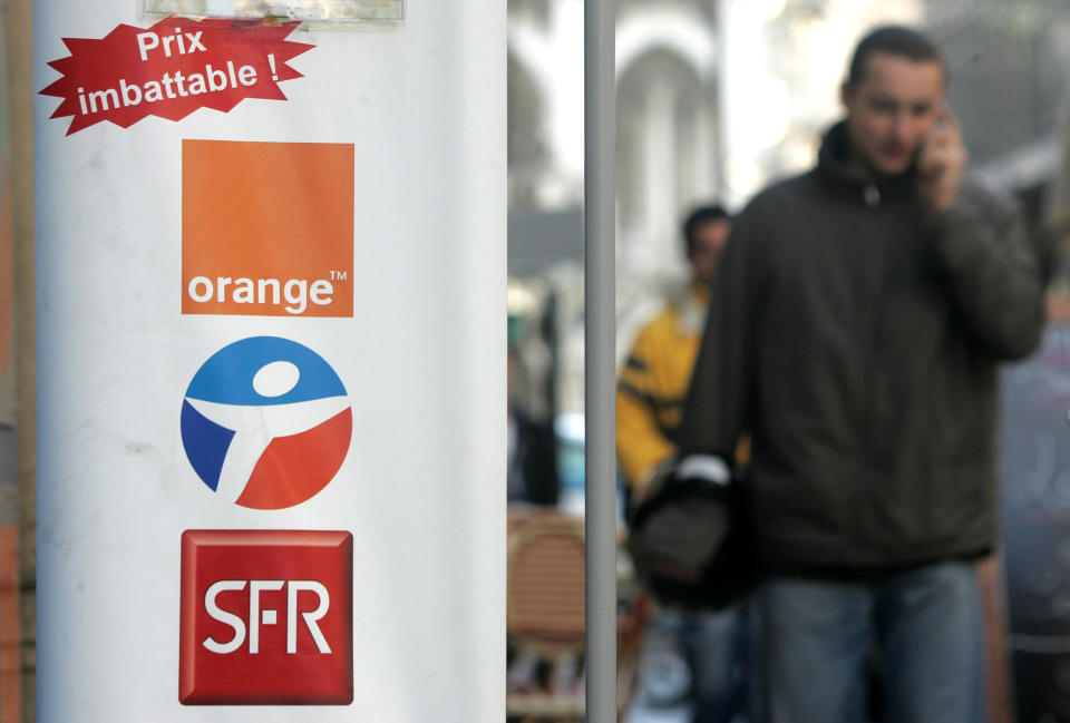 FILE - This Dec. 1, 2005, file photo shows three logos of French mobile operators : SFR, Bouygues and Orange, displayed at the entrance of a telephone store in Nice, southern France. French conglomerate Bouygues is offering euro10.5 billion ($14.4 billion) for control of mobile operator SFR telecommunications, entering a bidding war for the Vivendi unit. Bouygues said Thursday its offer to combine SFR with Bouygues Telecom would create a new number one mobile operator in France, leapfrogging current market leader Orange. (AP Photo/Lionel Cironneau, File)