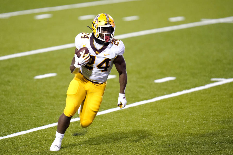 FILE - Minnesota running back Mohamed Ibrahim runs for a touchdown against Maryland during the first half of an NCAA college football game, Friday, Oct. 30, 2020, in College Park, Md. Many of Minnesota's upperclassmen cashed in on the bonus year of eligibility after the pandemic and returned for 2021, giving the Gophers one of the oldest teams in the Big Ten. The time is now for coach P.J. Fleck's group to take another step forward, led by running back Mo Ibrahim and quarterback Tanner Morgan, both in their fourth year. (AP Photo/Julio Cortez)