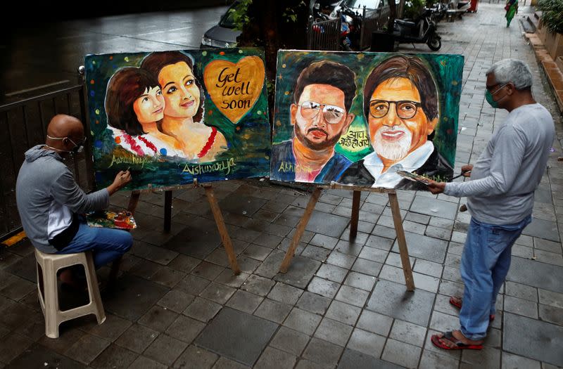 Artists create paintings depicting Bollywood actor Amitabh Bachchan, his son Abhishek Bachchan, his daughter-in-law Aishwarya Rai Bachchan and his granddaughter Aaradhya, after they tested positive for the coronavirus disease (COVID-19), in Mumbai