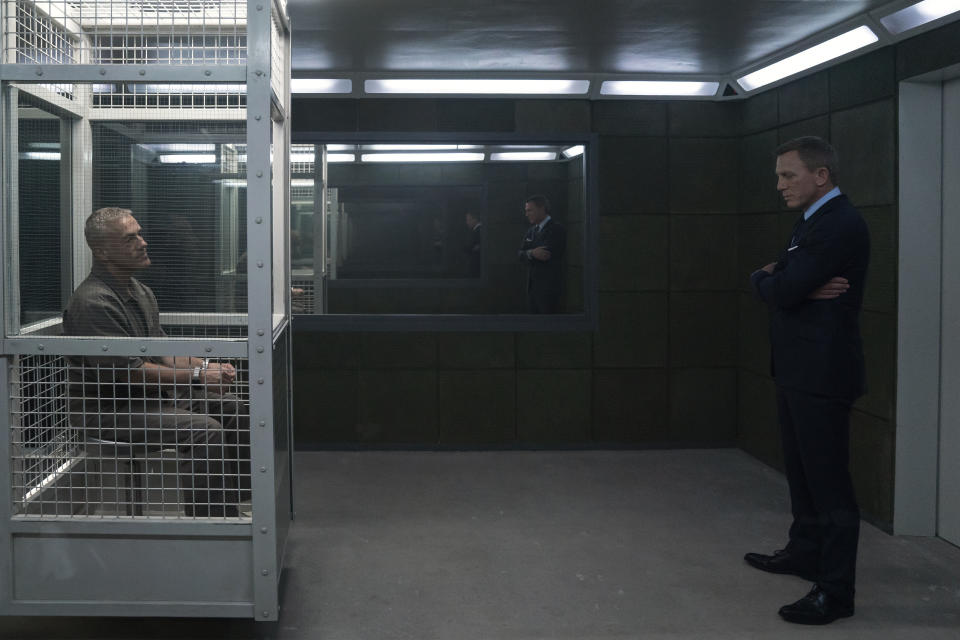 James Bond (Daniel Craig) visits Blofeld (Christoph Waltz) in his prison cell in NO TIME TO DIE. (Credit: Nicola Dove. © 2019 DANJAQ, LLC AND MGM)