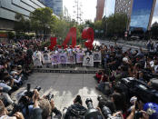 Relatives and classmates of the missing 43 Ayotzinapa college students pose for a photo in front of a monunent in their remembrance, in Mexico City, Monday, Sept. 26, 2022, on the day of the anniversary of the disappearance of the students in Iguala, Guerrero in 2014. Three members of the military and a former federal attorney general were recently arrested in the case, and few now believe the government's initial claim that a local drug gang and allied local officials were wholly to blame for seizing and killing the students on July 26, 2014, most of which have never been found. (AP Photo/Marco Ugarte)