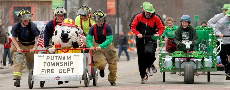 The bed race will return during Pinckney's St. Patrick's Day Parade, Saturday, March 16, 2024, after a hiatus. In this 2015 photo, Putnam Township firefighters race against team "Village People."
