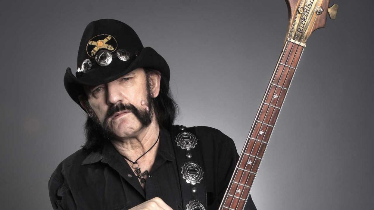  Lemmy holding his bass guitar - studio portrait. 