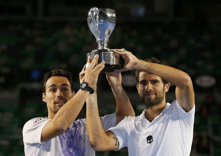 Simone Bolelli and Fabio Fognini of Italy pose with their trophy after defeating Pierre-Hugues Herbert and Nicolas Mahut of France in their men's doubles final match at the Australian Open 2015 tennis tournament in Melbourne January 31, 2015. REUTERS/Issei Kato