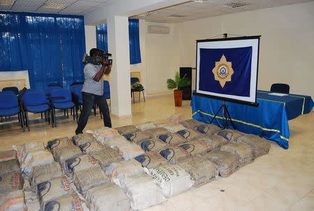 A journalist films drugs seized by Cape Verde's judicial police during their raid on targets involved in the Flying Boat case in Praia, Cape Verde, in this October 8, 2011 handout. REUTERS/Cape Verde Judicial Police/Handout via Reuters/Files