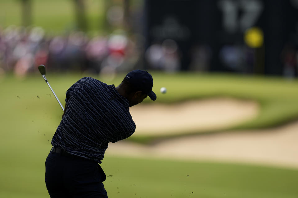 Tiger Woods hits from the fairway on the 17th hole during the first round of the PGA Championship golf tournament, Thursday, May 19, 2022, in Tulsa, Okla. (AP Photo/Eric Gay)