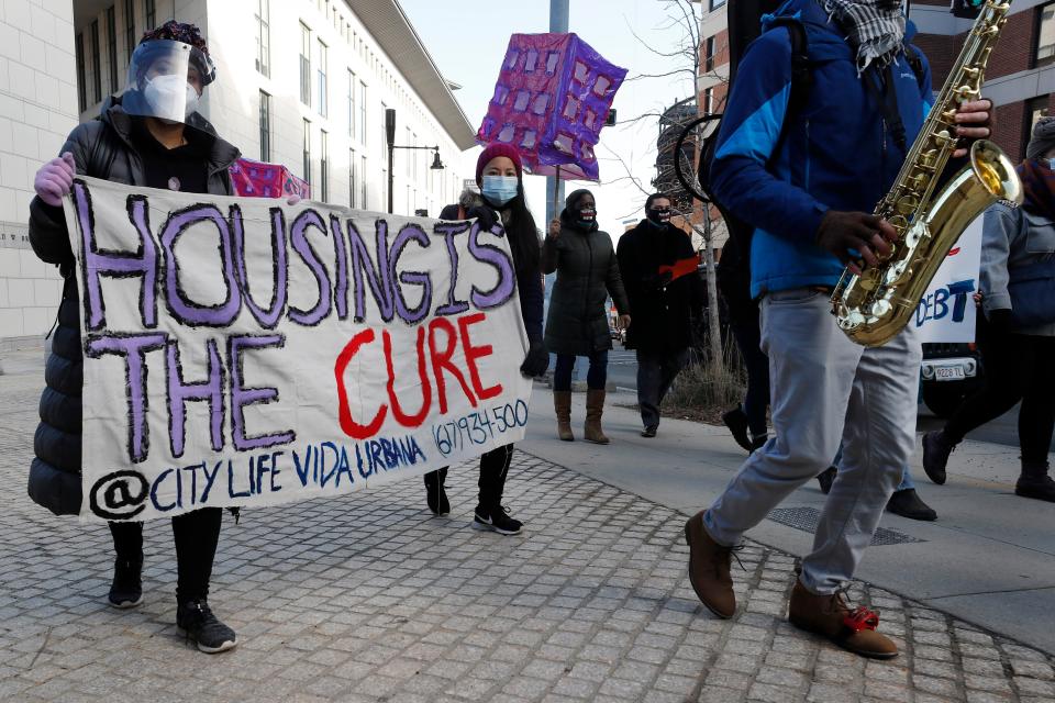 Tenants' rights advocates march to the JFK federal building, Wednesday, Jan. 13, 2021, in Boston. The protest was part of a national day of action calling on the Biden administration to extend an eviction moratorium initiated in response to the COVID-19 pandemic.