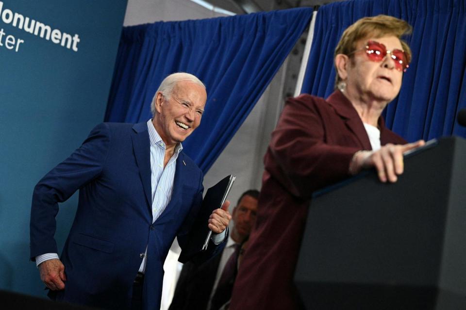 PHOTO: President Joe Biden laughs as British musician Elton John speaks during the Stonewall National Monument Visitor Center grand opening ceremony in New York City,June 28, 2024.  (Mandel Ngan/AFP via Getty Images)