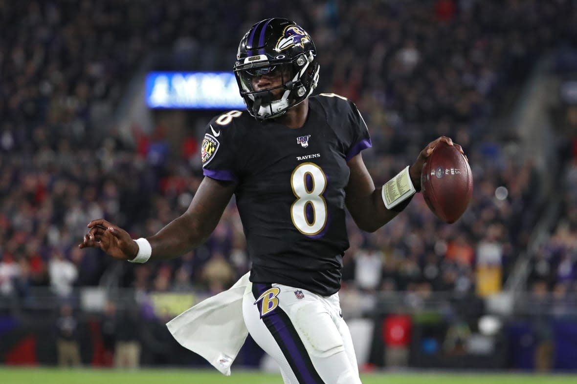 Quarterback Lamar Jackson #8 of the Baltimore Ravens scores a first-quarter touchdown against the New England Patriots at M&T Bank Stadium on November 3, 2019 in Baltimore, Maryland. (Photo by Todd Olszewski/Getty Images)