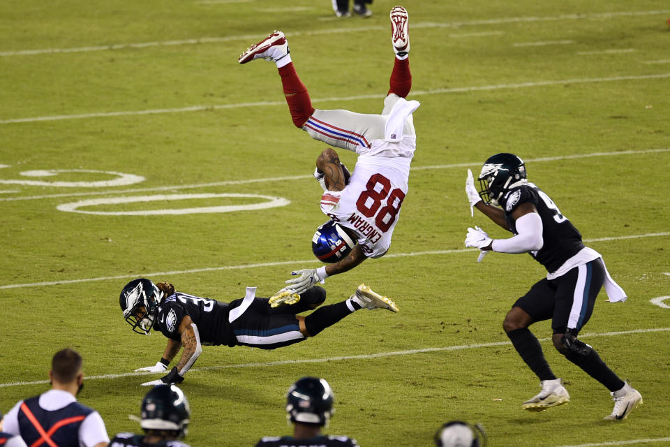 New York Giants' Evan Engram (88) tumbles after trying to leap over Philadelphia Eagles' Cre'Von LeBlanc (34) as Josh Sweat (94) defends during the second half of an NFL football game, Thursday, Oct. 22, 2020, in Philadelphia. (AP Photo/Derik Hamilton)