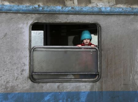 A migrant child looks out of a train window at a train station in the town of Sid, Serbia February 12, 2016. REUTERS/Marko Djurica TPX IMAGES OF THE DAY