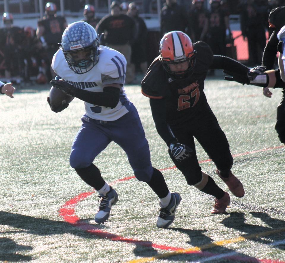 Somersworth's Tayshawn Sheppard tries to turn the corner during Saturday's Division IV championship game in Laconia.