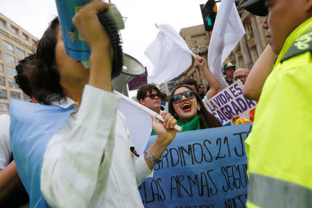 People take part in a rally against violence, following a car bomb explosion, in Bogota, Colombia January 20, 2019. REUTERS/Luisa Gonzalez