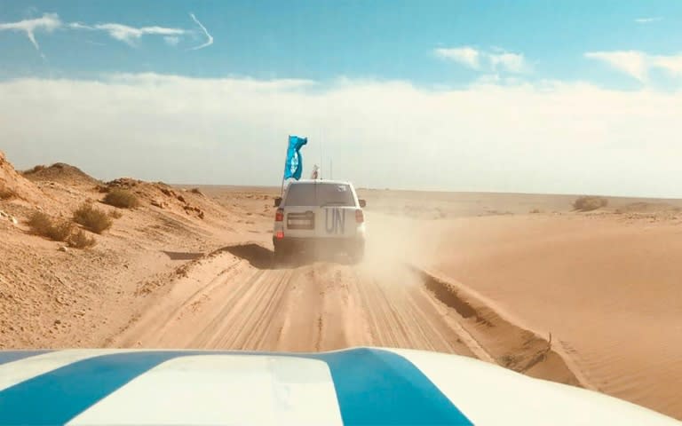 In this handout photo released by the United Nations Coordination Support Office in Syria on November 3, 2018, a UN and Syrian Arab Red Cross convoy drives into the Rukban desert camp for displaced Syrians along the border with Jordan to deliver aid