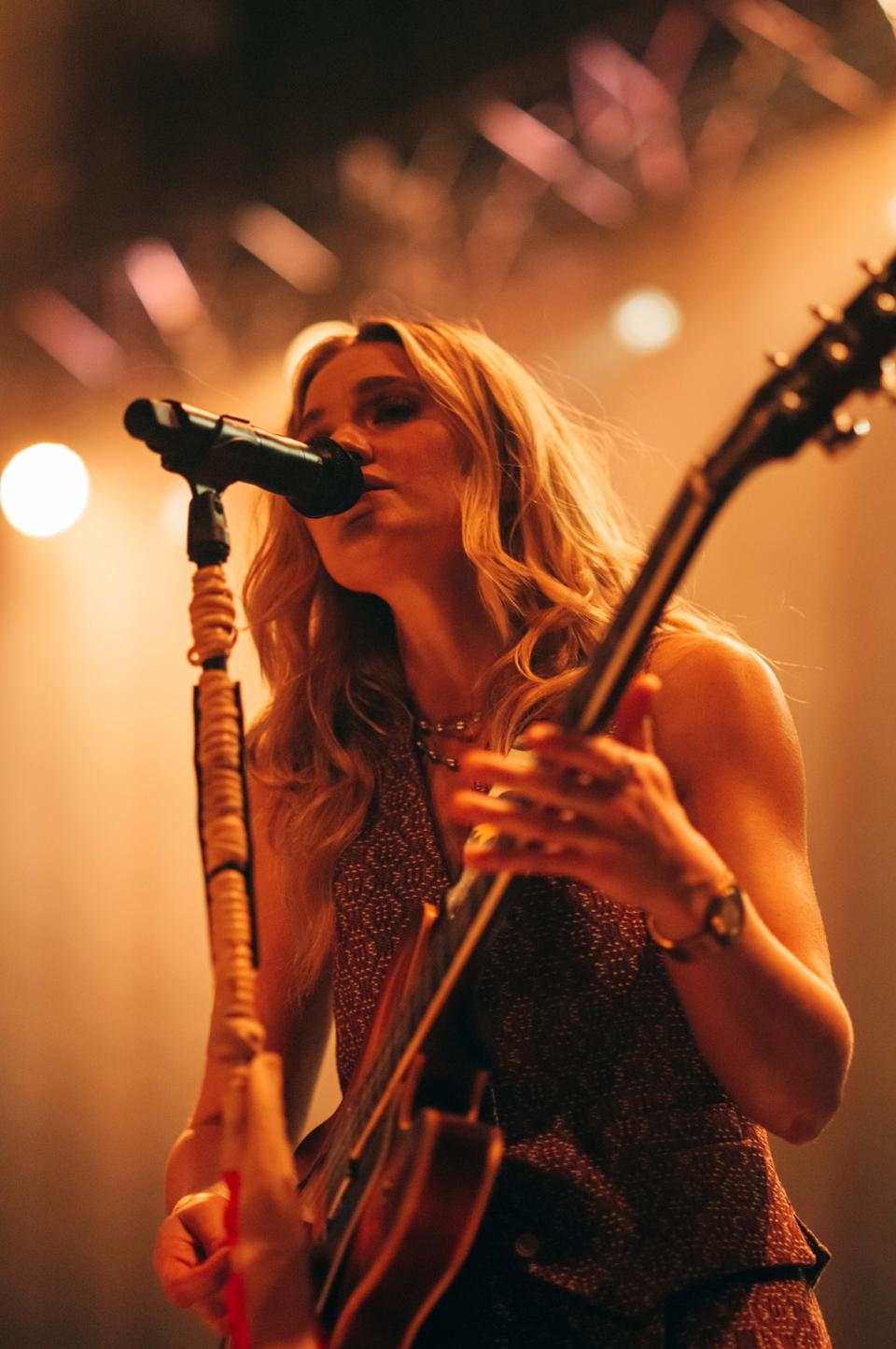 AJ Michalka of AJ & Aly in concert wearing a 1959 Audemars Piguet 18-karat gold “Disco Volante” timepiece. - Credit: Stephen Ringer