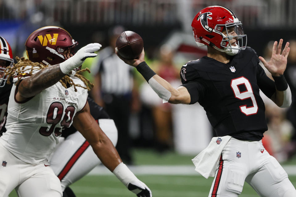 Atlanta Falcons quarterback Desmond Ridder (9) passes the ball as Washington Commanders defensive end Chase Young (99) defends during the first half of an NFL football game, Sunday, Oct. 15, 2023, in Atlanta. (AP Photo/Butch Dill)