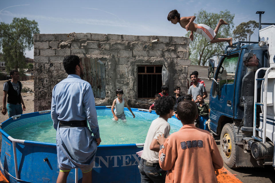 <p>Children play in a pool of water in the Harat Al-Masna’a slum in Sana’a, Yemen, April 28, 2017. This slum, which is close to an urban military base, was hit by two airstrikes last year on the day of the Eid Al-Adha, destroying 25 houses. (Photograph by Giles Clarke for UN OCHA/Getty Images) </p>