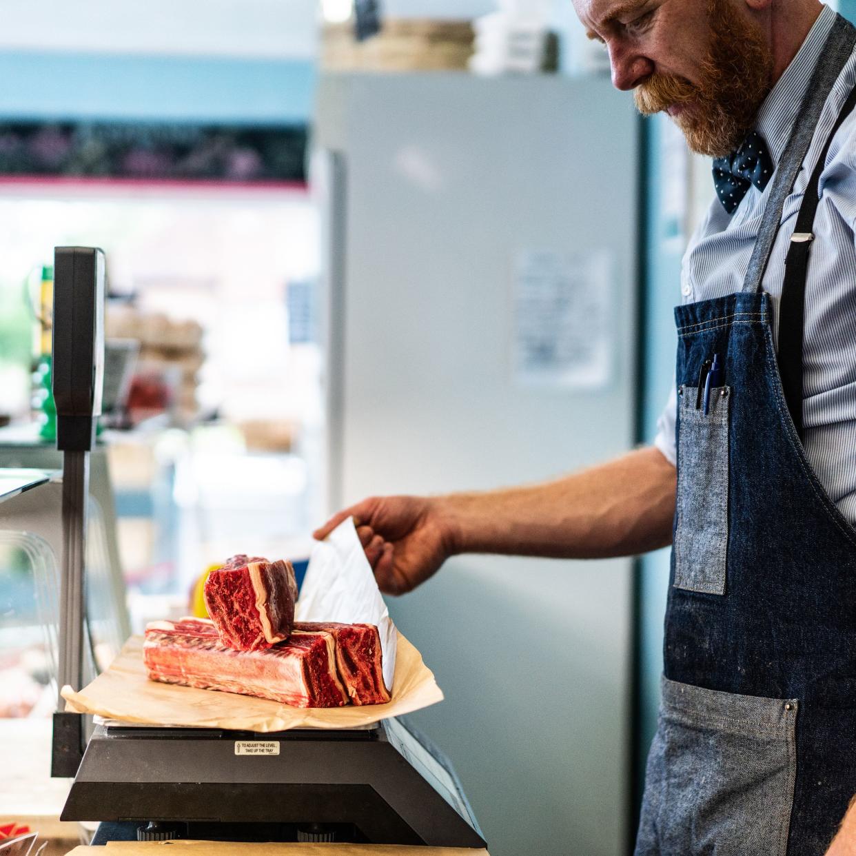 butcher weighing dry aged beef short rib