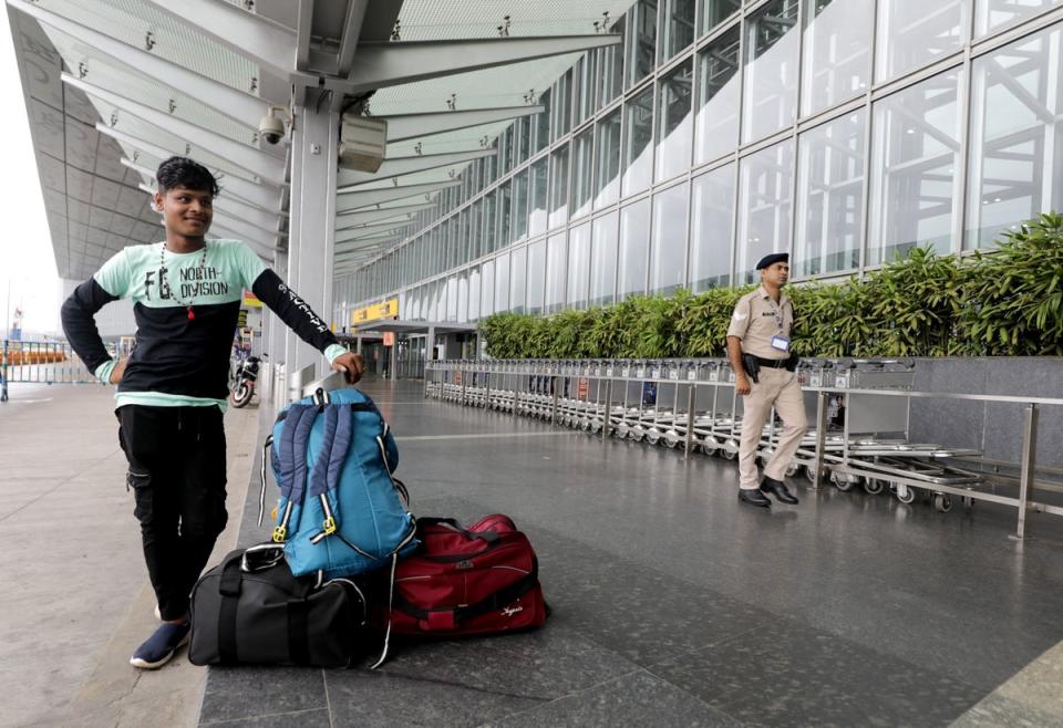 A man waits as flights are suspended at Netaji Subhas Chandra Bose airport due to an approaching cyclone in Kolkata, India 26 May 2024 (EPA)