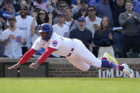 Chicago Cubs pinch runner Nelson Velazquez scores on Nick Madrigal's single during the eighth inning of a baseball game against the Miami Marlins on Saturday, May 6, 2023, in Chicago. The Cubs won 4-2. (AP Photo/Charles Rex Arbogast)