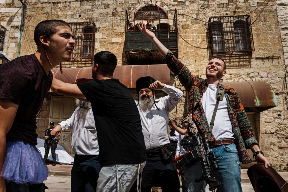 Religious Israeli dress up in costumes march in a parade to celebrate Purim in Hebron, Occupied West Bank , in March