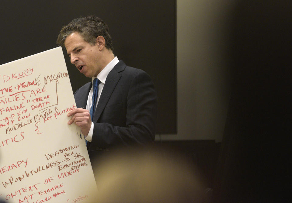 Attorney Josh Koskoff, attorney for the families, holds a list of subjects during his rebuttal of Norm Pattis, attorney for Alex Jones closing statements, in the Alex Jones Sandy Hook defamation damages trial in Superior Court in Waterbury on Thursday, October 6, 2022. (H John Voorhees III/Hearst Connecticut Media via AP, Pool)