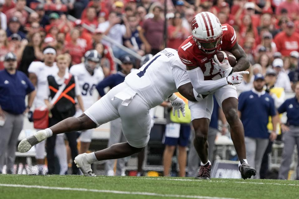 Wisconsin's Skyler Bell (11) tries to get past Georgia Southern's Marques Watson-Trent (1) during the first half of an NCAA college football game Saturday, Sept. 16, 2023, in Madison, Wis. (AP Photo/Morry Gash)