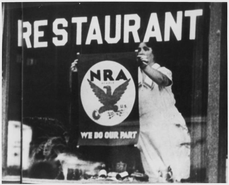 lossy page1 743px NRA Blue_Eagle_Emblem poster_displayed_in_restaurant_window_stating_their_participation_and_support_for_government..._ _NARA_ _196519.tif