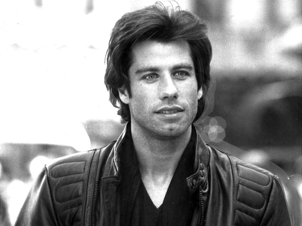 black and white photo of John Travolta wearing a black leather jacket