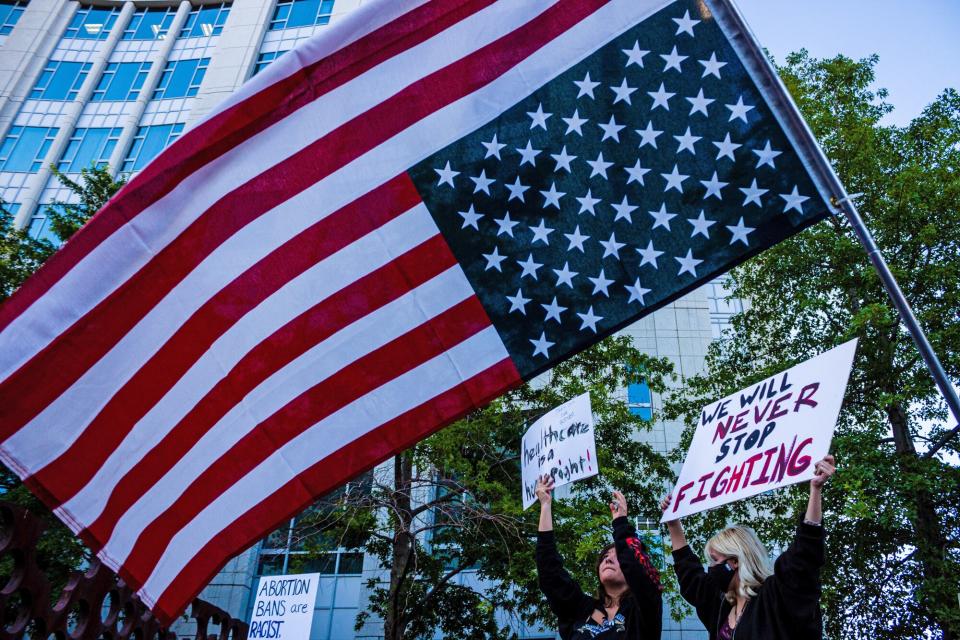 An upside down American flag during Scotus protest. Protestors gather after SCOTUS over turned Roe v. Wade. Hundreds of protesters took to the street to protest against he Court's decision in the Dobbs v Jackson Women's Health case overturns the landmark 50-year-old Roe v Wade case, removing a federal right to an abortion.