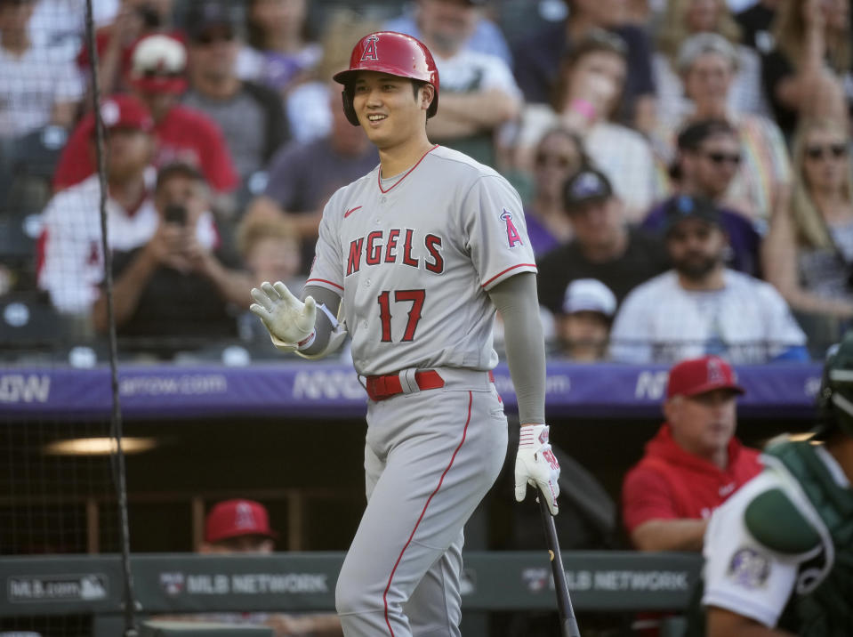 Los Angeles Angels' Shohei Ohtani waves as he waits in the on-deck circle to bat in the first inning of the team's baseball game against the Colorado Rockies on Saturday, June 24, 2023, in Denver. (AP Photo/David Zalubowski)