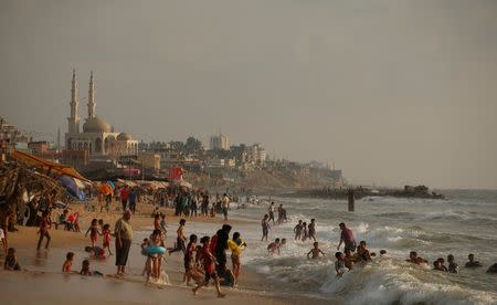 Palestinians swim in the Mediterranean Sea in Beit Lahiya town, in the northern Gaza Strip, July 6, 2017. REUTERS/Mohammed Salem