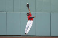 FILE - Boston Red Sox center fielder Jackie Bradley Jr. makes a leaping catch on a ball hit by Toronto Blue Jays' Rowdy Tellez during the sixth inning of the first baseball game of a doubleheader at Fenway Park in Boston, in this Friday, Sept. 4, 2020, file photo. Free-agent outfielder Jackie Bradley Jr. is joining the Milwaukee Brewers, agreeing to the parameters of a $24 million, two-year contract, a person familiar with the negotiations told The Associated Press. The person spoke on condition of anonymity Thursday, March 4, 2021, because the details of the agreement were still being negotiated and the deal is subject to a successful physical.(AP Photo/Winslow Townson, File)