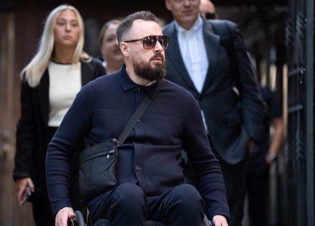 Martin Hibbert in a wheelchair outside the Royal Courts Of Justice 